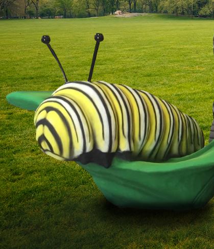 A larger than life black and yellow caterpillar on a green leaf that is a climber for playgrounds