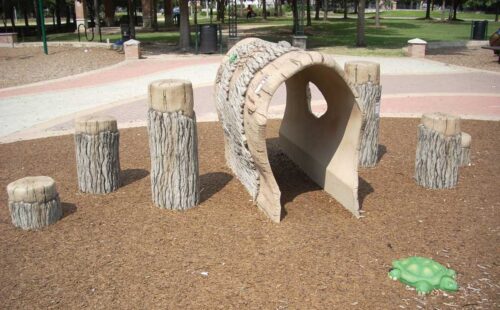 Playground with log tunnel, land turtle stepper and log steppers.