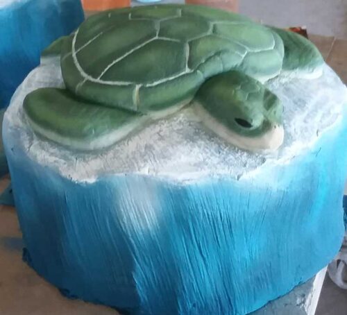 Sea turtle on top of a wave of water. To be used on a playground as a stepper that leads to a larger playground piece.