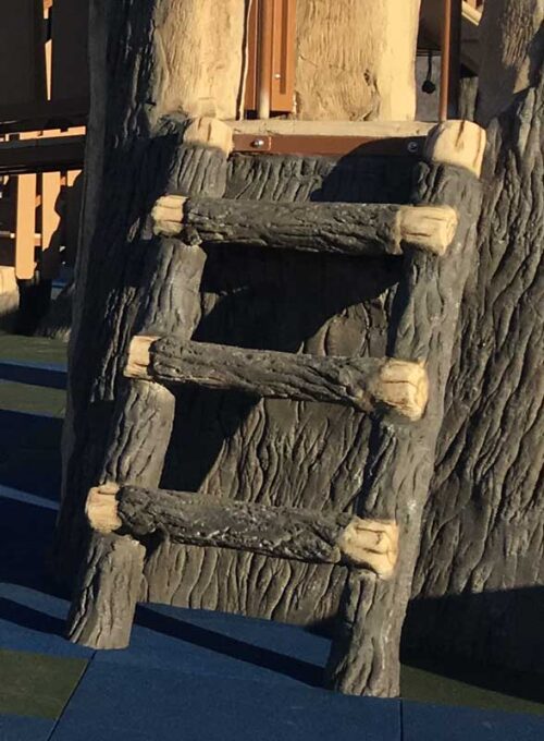 Climber made to look like a ladder built with logs that provides access to upper deck of playground structure