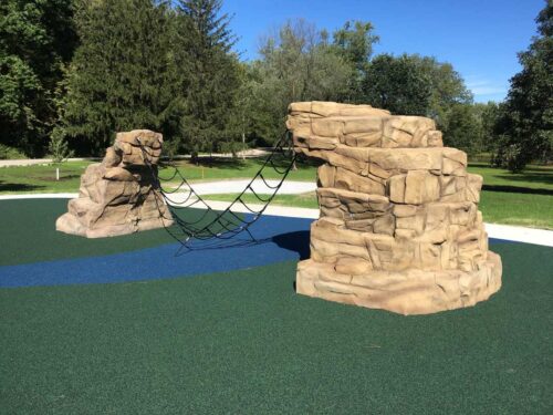 Rock N' Rope 210 is a play structure that consists of two climbing rocks with a climbing net between the two to provide an obstacle course for kids