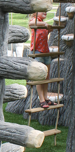 A kid climbs up a steady ladder climber to reach a TreeLine series playground deck